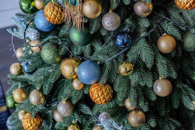 Multicolored christmas tree decorations closeup of a christmas tree with garlands and glass balls