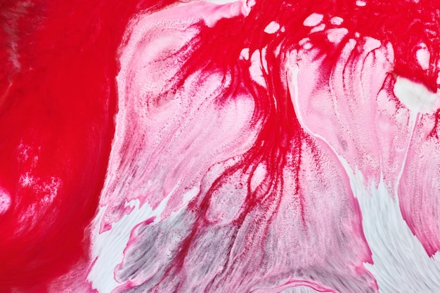 Multicolored creative abstract background Red pink alcohol ink Waves stains spots and strokes of paint marble texture