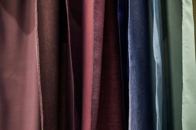 multicolored curtains in the store texture of multicolored fabrics fabric hanging in the store