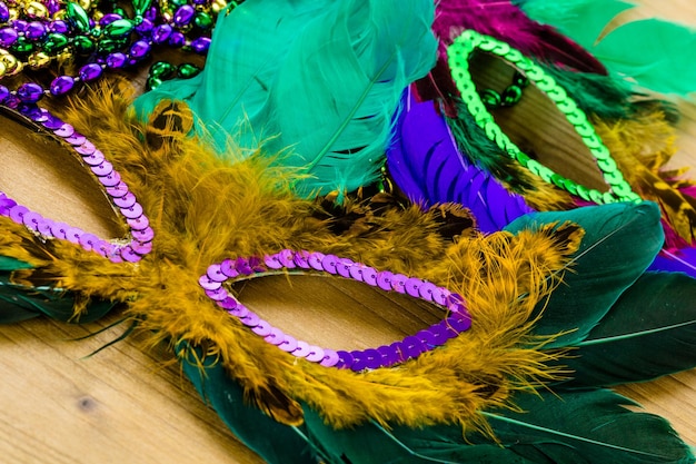 Multicolored decorations for Mardi Gras party on the table.