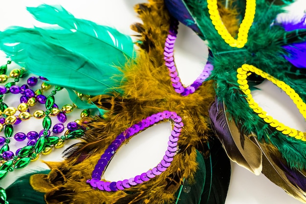 Multicolored decorations for Mardi Gras party on the table.