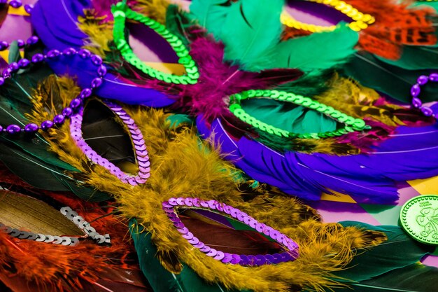 Multicolored decorations for Mardi Gras party on the table.