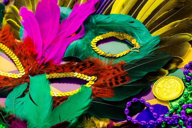 Multicolored decorations for Mardi Gras party on the table.