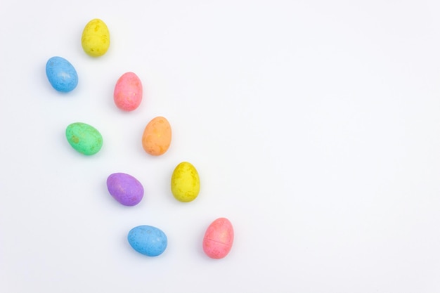 Multicolored Easter eggs on a white background Space for text