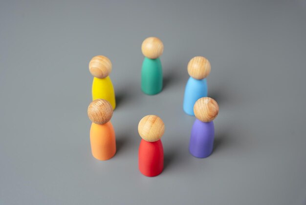 Multicolored figures of people stand in a circle Cooperation and unity of the LGBT community