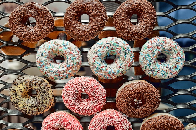 Multicolored glazed donuts on a wire rack Fast Food Concept Delicious Dessert