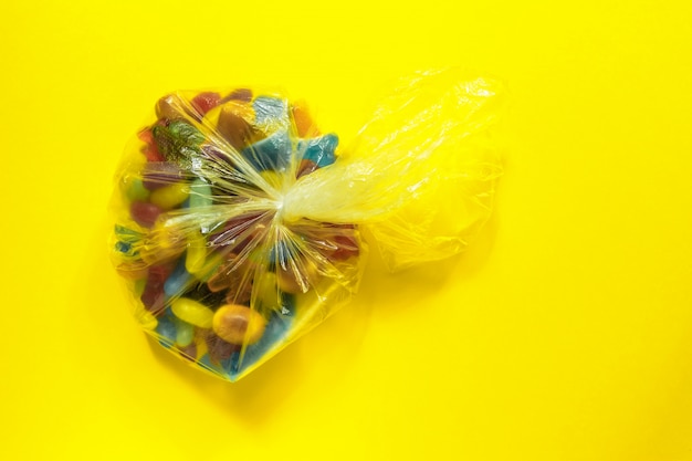 Multicolored glazed jelly beans in a plastic bag