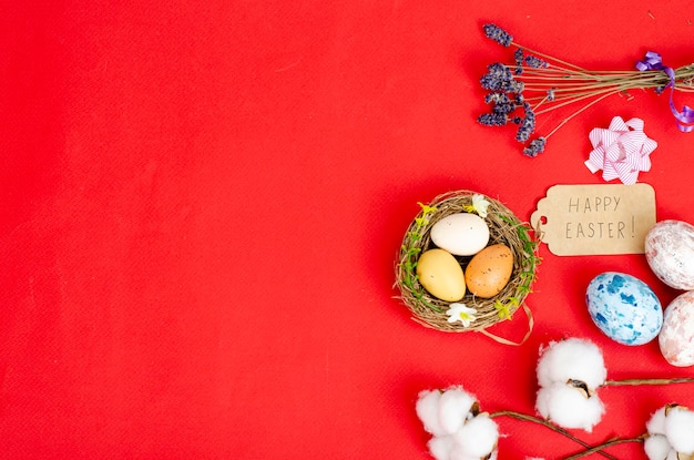 Multicolored handmade easter eggs and confetti on pink background. Minimal concept. View from above. Space for text. Studio Photo