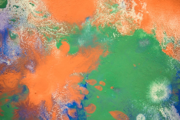 Multicolored paint stains drips splashes mixing. Abstract background