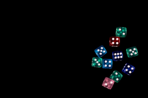 Multicolored playing dice isolated on black background