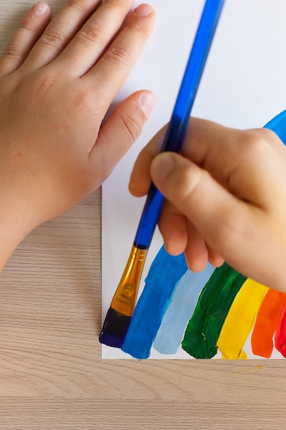 Multicolored rainbow with gouache paints Children's drawing in their free time