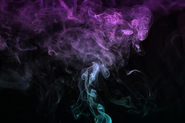 Multicolored smoke for aromatherapy relaxation on black background beautiful swirled puffs of smoke