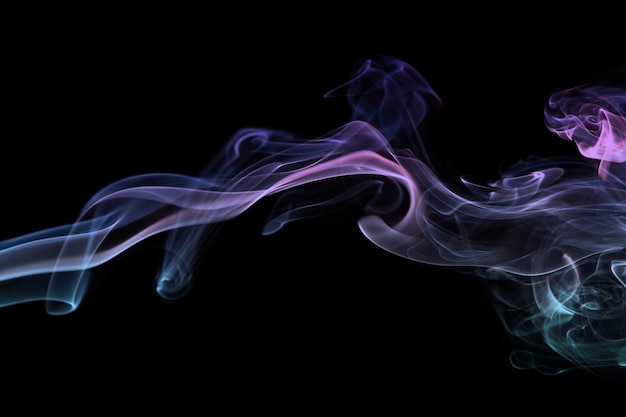 Multicolored smoke for aromatherapy relaxation on black background beautiful swirled puffs of smoke