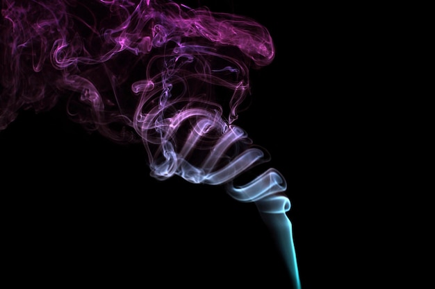 Multicolored smoke for aromatherapy relaxation on black background beautiful swirled puffs of smoke