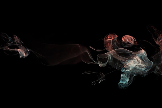 Multicolored smoke for aromatherapy relaxation black background beautiful swirled puffs of smoke