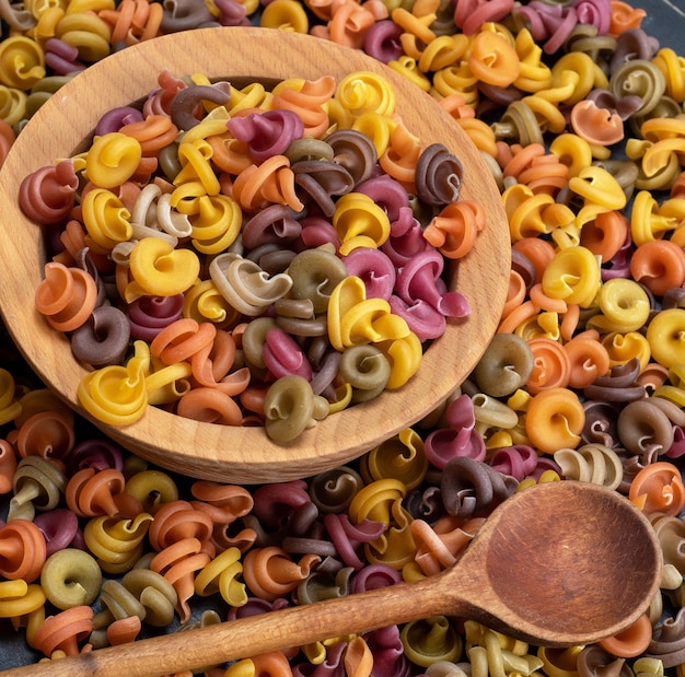 Multicolored spiral raw pasta fusilli 