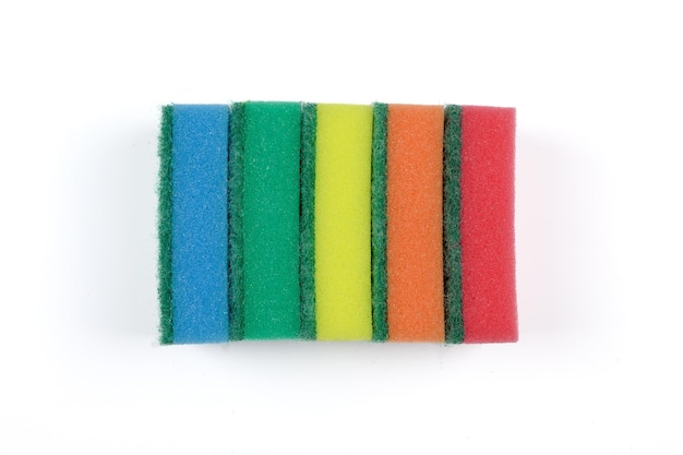 Multicolored sponges for washing disheson a white background CloseupTop view