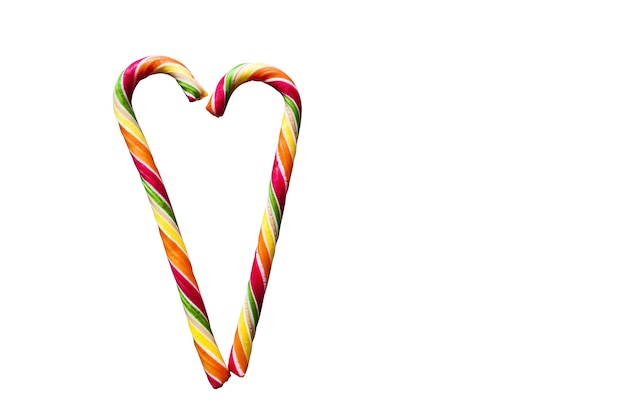 Multicolored striped heart-shaped lollipops on a white background. Christmas, New Year, 