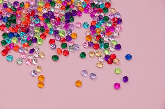 Multicolored tiny faceted crystals on a pink background beautiful colorful texture