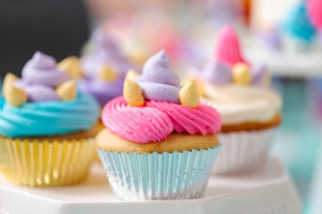 Multicolored unicorn cupcakes at little girl birthday party.