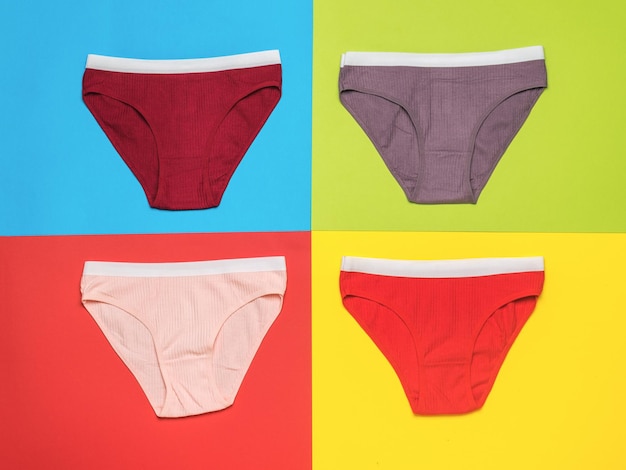 Multicolored women's panties on a multicolored background Minimal concept of women's underwear