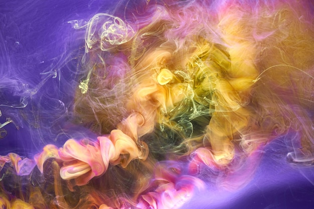 Multicolored yellow lilac smoke abstract background acrylic paint underwater explosion