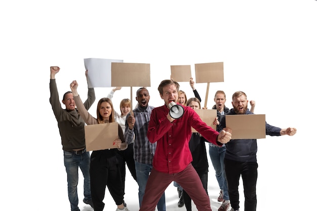 Multicultural group of people screaming while holding blank placards on white wall