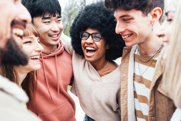 Multicultural group of young people having fun together outside