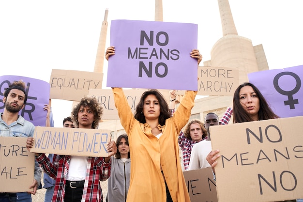 Multiethnic feminist holding banners placards with feminist slogans