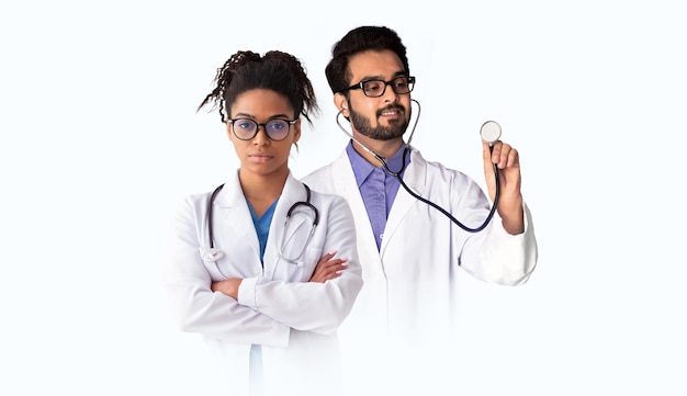 Multiethnic Male And Female Doctors In Medical Coats With Stethoscope Standing Isolated Over White Background