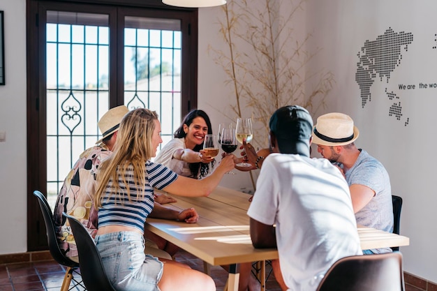 Multiethnic meeting toasts with wine while playing dice