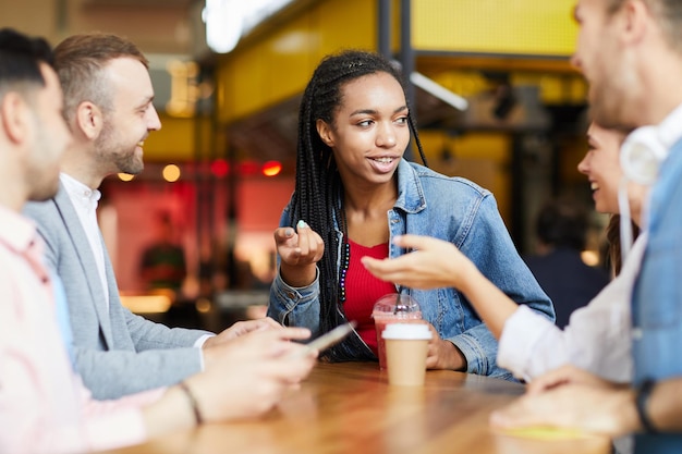 Multiethnic students chatting in cafe