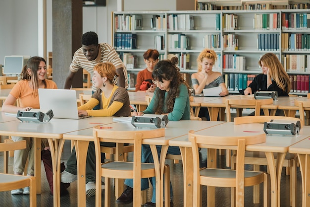 Multiethnic students doing homework in modern library