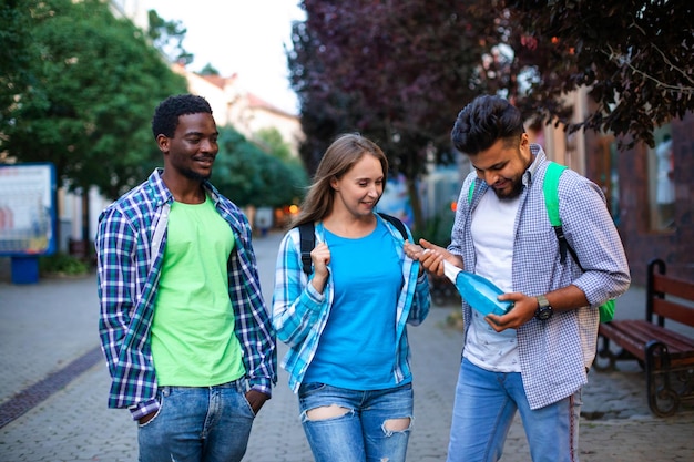 The multiethnic students with a bottle of nonalcoholic sparkling wine