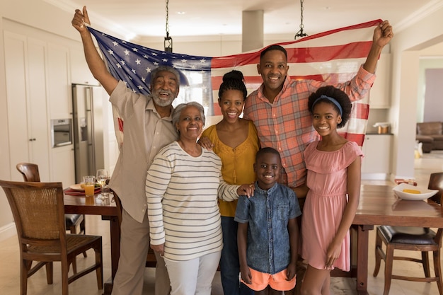 Photo multigeneration family holding an american flag at home