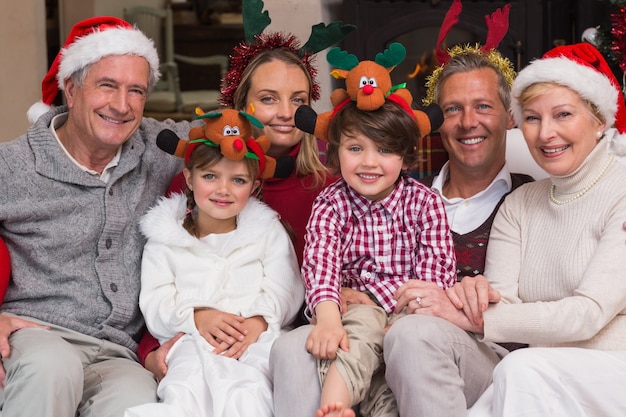 Multigeneration family wearing santa hats on the couch