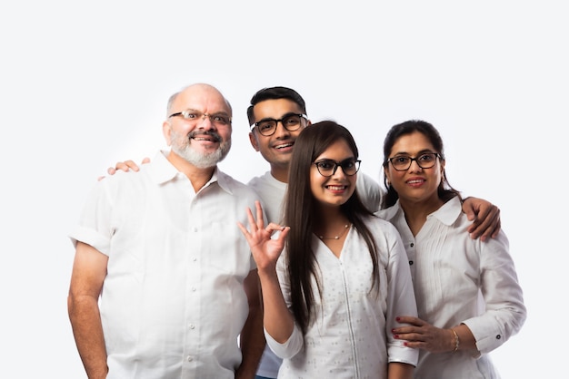 Multigenerational Indian asian smart family wears clear eye glasses or spects or spectacles against white background