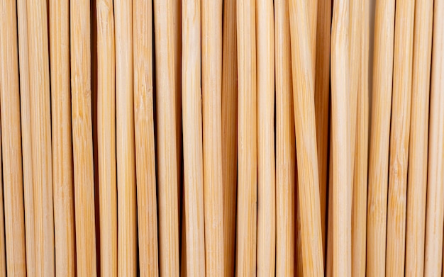 multiple wooden bamboo skewers laying on white background macro long wooden skewers for grilling