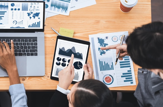 Multiracial analyst team use BI Fintech software to analyze financial data on meeting Top view finance dashboard data display on laptop screen with analyzed chart for marketing indication Concord