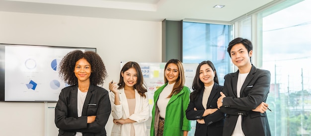 Multiracial business team on a meeting in a modern bright office Diverse colleagues working on project together sitting at table in boardroom