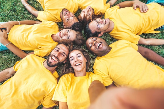 Multiracial community of young people smiling together at camera