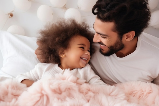 Multiracial diverse young family couple playing with cute baby child in bed holding infant kid girl Happy multiethnic parents having fun in the morning lifting small daughter in bedroom at home