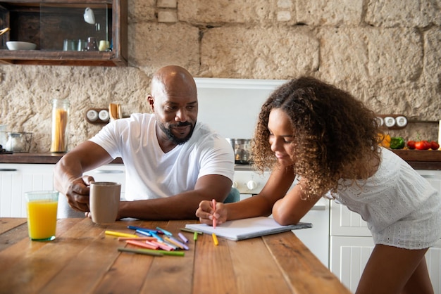 Multiracial family sharing their time in the kitchen of the home