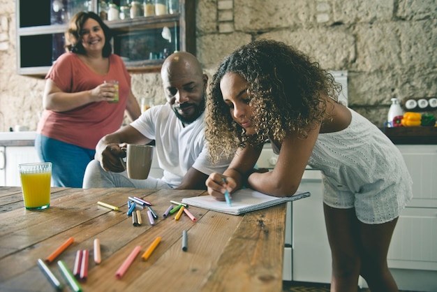 Multiracial family sharing their time in the kitchen of the home