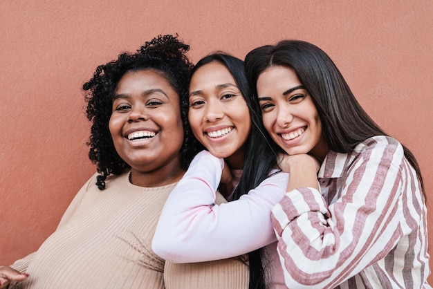 Multiracial friends having fun together outdoor - Focus on faces