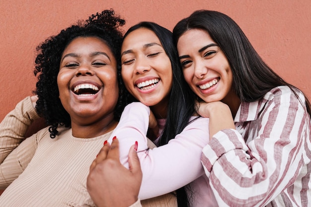 Multiracial friends having fun together outdoor - Focus on faces