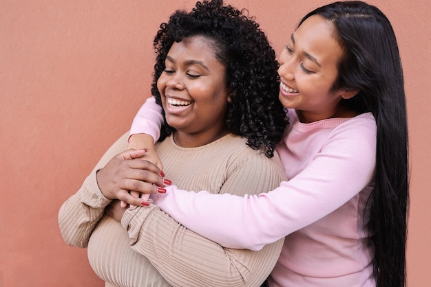 Multiracial friends having fun together outdoors in the city - Main focus on right girl face