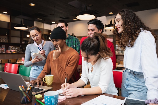 Multiracial mixed group of young people sitting at desk Coworkers or teamwork