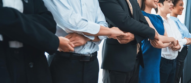 Multiracial office worker hold hand in a line promoting synergy Concord