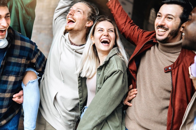 Photo multiracial young people laughing and celebrating victory event outside